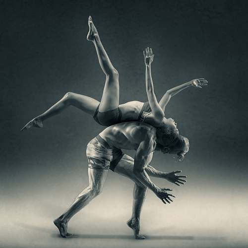 dance pose A woman flipping over a man, back to back. dance